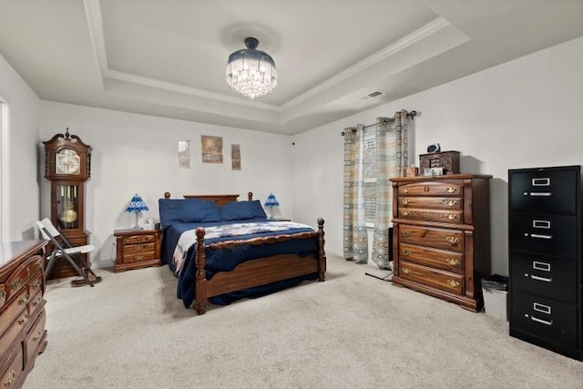 carpeted bedroom featuring crown molding, a tray ceiling, and a notable chandelier