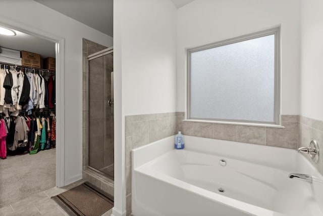 bathroom with tile patterned flooring and separate shower and tub