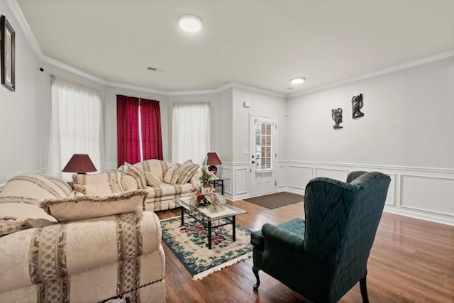 living room with dark wood-type flooring and ornamental molding