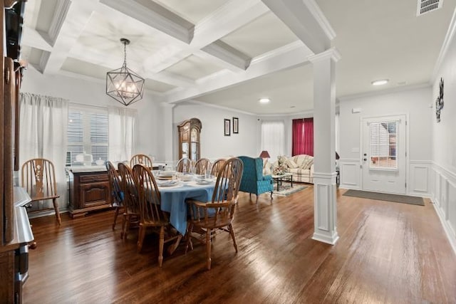 dining room featuring ornate columns, dark hardwood / wood-style flooring, and beam ceiling