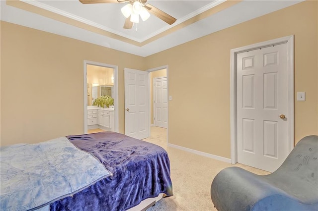 carpeted bedroom with ceiling fan, ensuite bath, and ornamental molding