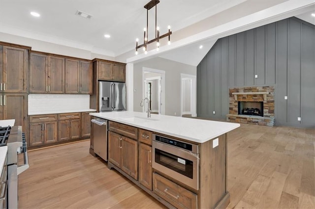 33 Cedar Gate Ln, Kingston, GA 30145 - kitchen featuring stainless steel appliances, a sink, light wood-type flooring, vaulted ceiling, and light countertops