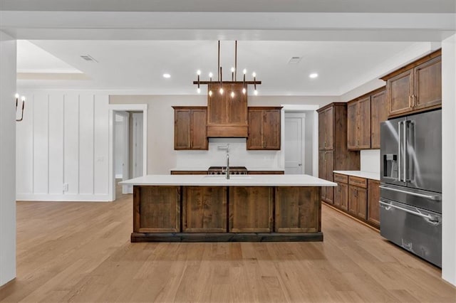 33 Cedar Gate Ln, Kingston, GA 30145 - kitchen with high quality fridge, light countertops, light wood-style floors, a large island with sink, and a sink