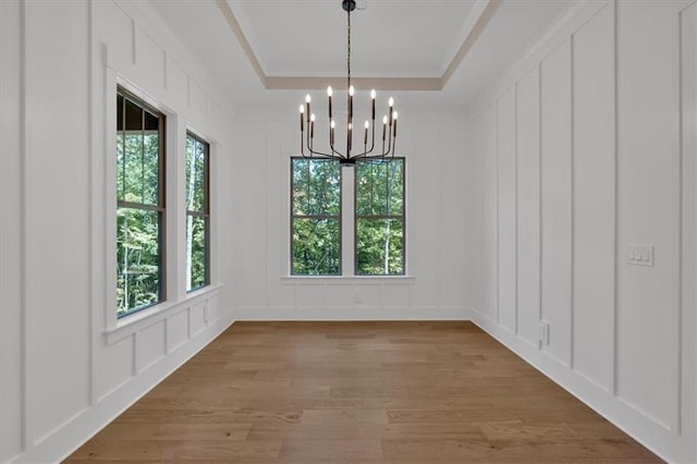 33 Cedar Gate Ln, Kingston, GA 30145 - unfurnished dining area featuring a decorative wall, plenty of natural light, a chandelier, light wood-type flooring, and a raised ceiling