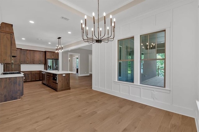 33 Cedar Gate Ln, Kingston, GA 30145 - kitchen with a chandelier, a decorative wall, light countertops, light wood finished floors, and stainless steel appliances