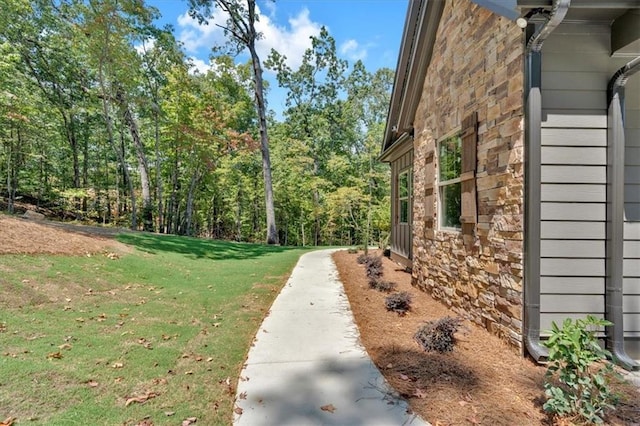 33 Cedar Gate Ln, Kingston, GA 30145 - view of side of home with stone siding, a lawn, and a wooded view