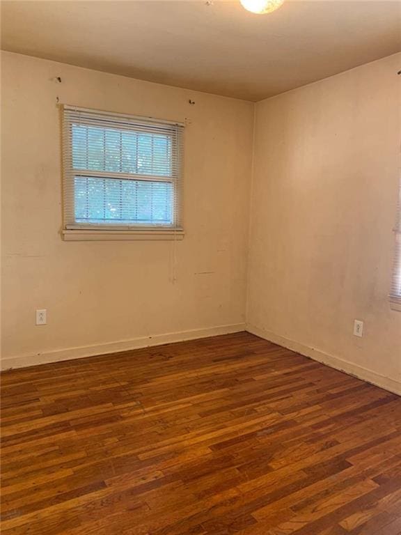 unfurnished room featuring dark wood-type flooring