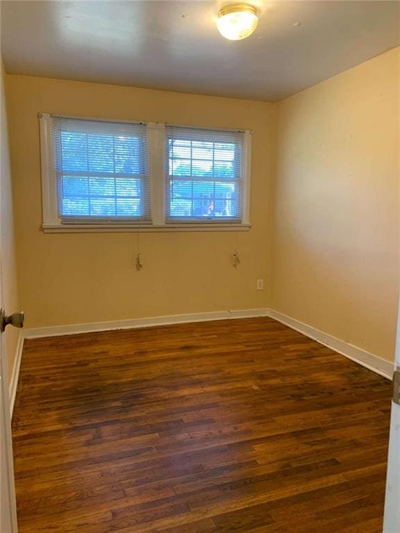 spare room featuring dark hardwood / wood-style floors