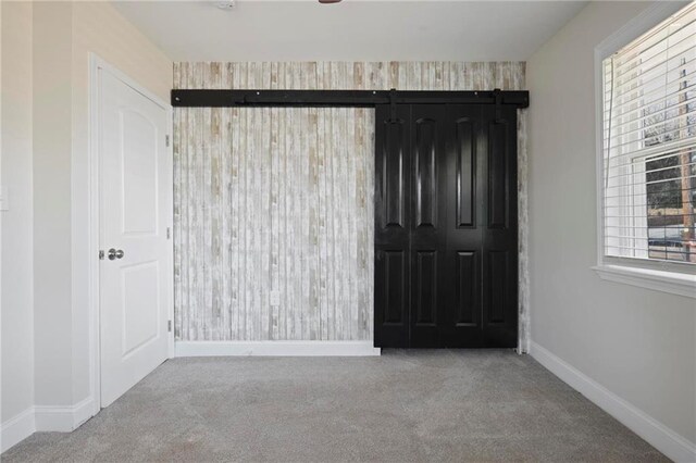 unfurnished bedroom featuring light carpet, a ceiling fan, visible vents, and baseboards