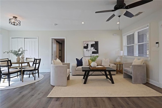 living room with ceiling fan and light wood-type flooring