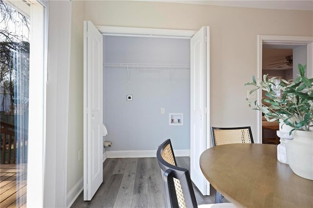 laundry room with laundry area, baseboards, dark wood-type flooring, hookup for a washing machine, and electric dryer hookup