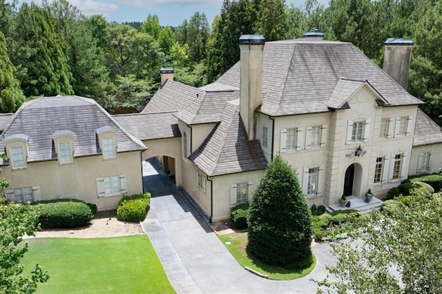 french provincial home featuring a front lawn