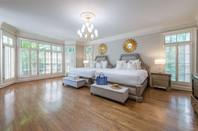 bedroom with wood-type flooring, ornamental molding, and a notable chandelier