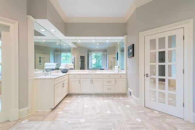 bathroom with vanity, crown molding, and parquet floors