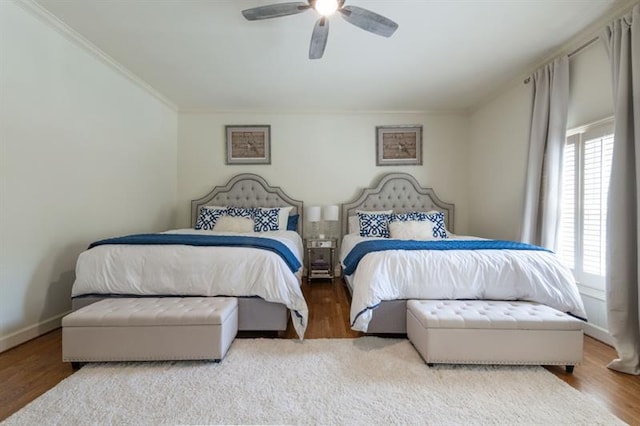 bedroom featuring ceiling fan, wood-type flooring, and ornamental molding