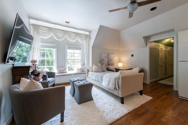 bedroom featuring ceiling fan, dark hardwood / wood-style floors, and white refrigerator