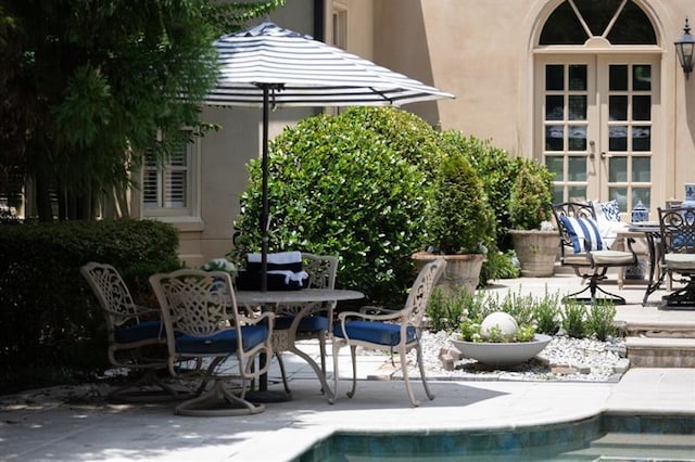 view of pool featuring a patio area and french doors