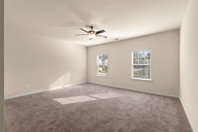 carpeted empty room featuring ceiling fan