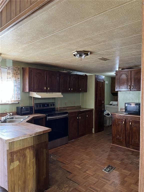 kitchen featuring stainless steel range with electric stovetop, dark brown cabinetry, sink, and dark parquet floors