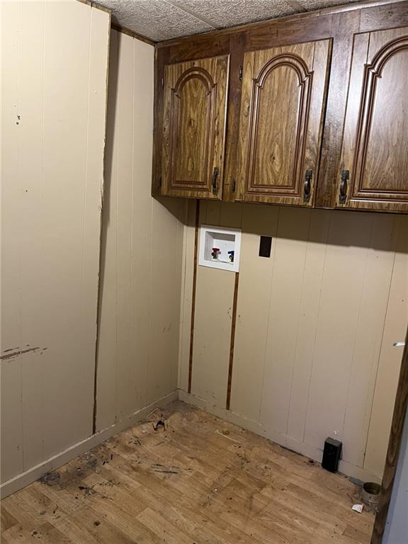 laundry area featuring cabinets, hookup for a washing machine, and light wood-type flooring