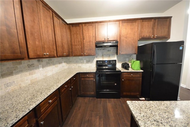 kitchen with black appliances, tasteful backsplash, dark hardwood / wood-style floors, and light stone countertops