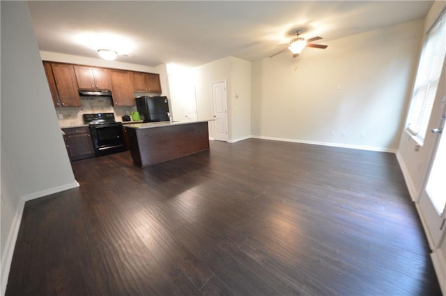 kitchen featuring black appliances, decorative backsplash, a kitchen island, dark wood-type flooring, and ceiling fan