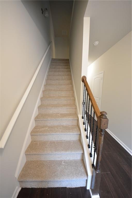 stairway featuring wood-type flooring