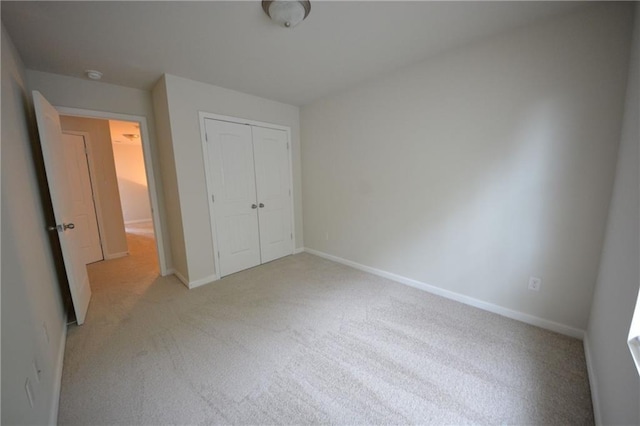 unfurnished bedroom with a closet and carpet