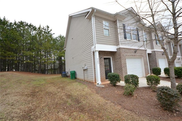 view of property exterior with a garage, cooling unit, and a lawn