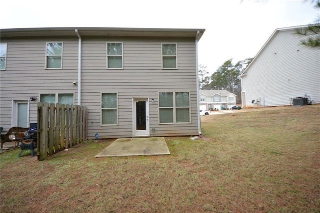 rear view of property with a patio area, a lawn, and central AC