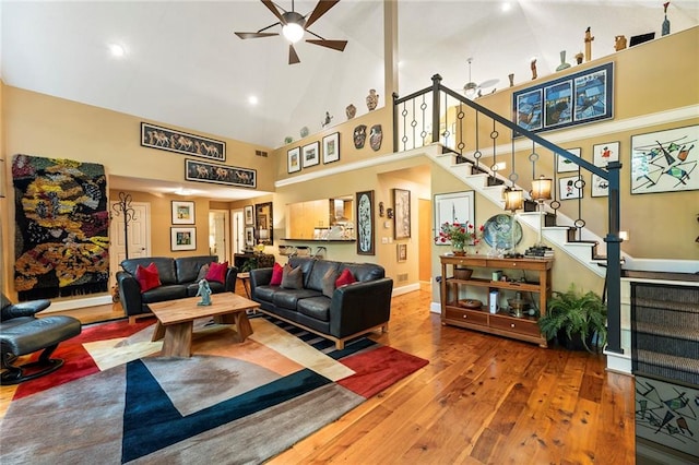 living room featuring ceiling fan, wood-type flooring, and high vaulted ceiling