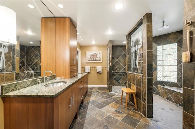 bathroom with vanity and tile walls