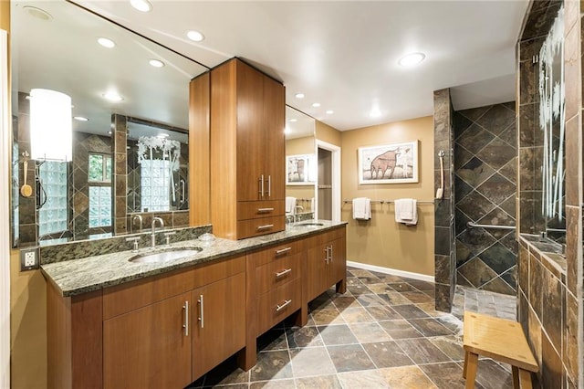 bathroom featuring tiled shower and vanity