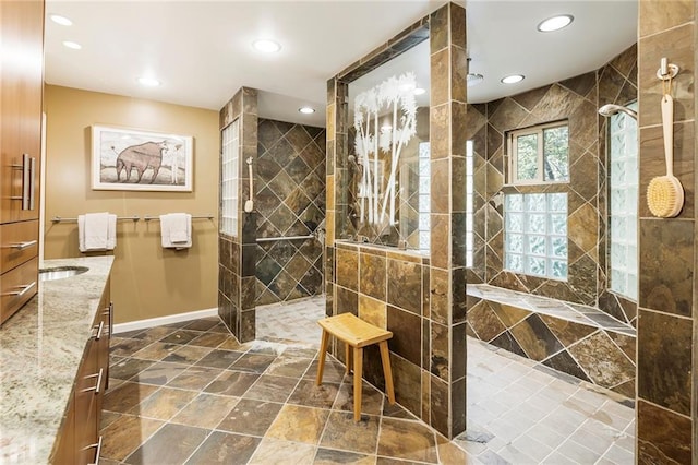 bathroom with vanity and tiled shower