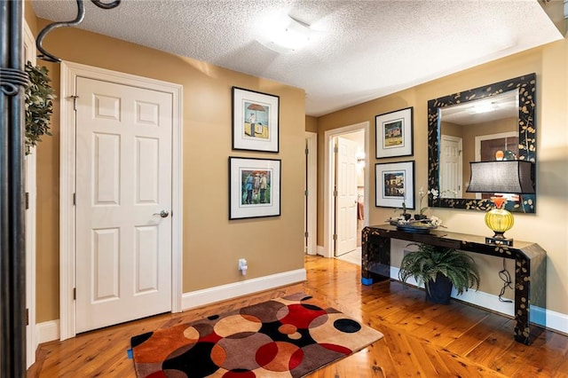 interior space with a textured ceiling and hardwood / wood-style flooring