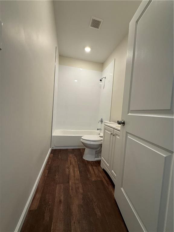 bathroom with wood finished floors, washtub / shower combination, baseboards, toilet, and visible vents