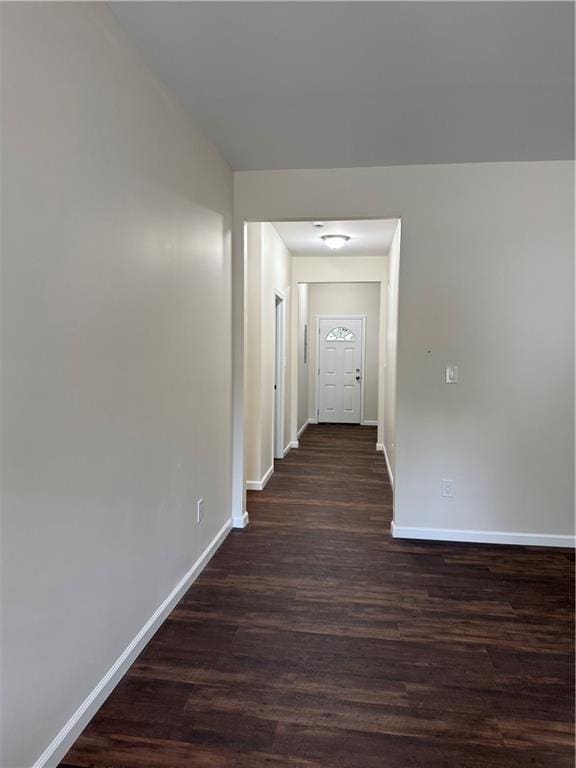 hallway with baseboards and dark wood-style floors