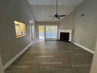 unfurnished living room featuring high vaulted ceiling, ceiling fan, and dark wood-type flooring