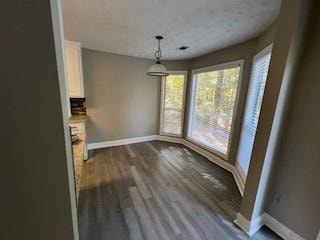 unfurnished dining area featuring hardwood / wood-style flooring