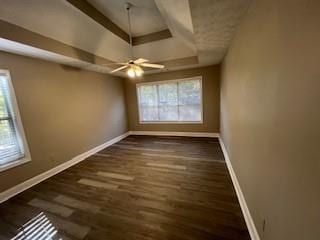 unfurnished room featuring ceiling fan and dark hardwood / wood-style floors