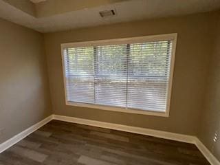 unfurnished room with dark hardwood / wood-style flooring