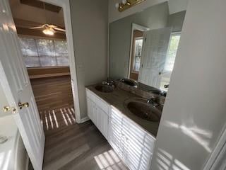 bathroom featuring wood-type flooring, vanity, and ceiling fan