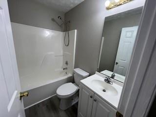 full bathroom with shower / tub combination, vanity, hardwood / wood-style flooring, and toilet