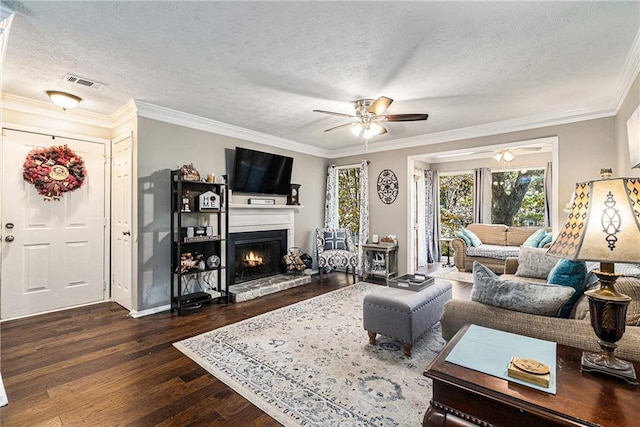 living room featuring dark hardwood / wood-style flooring, a textured ceiling, and crown molding