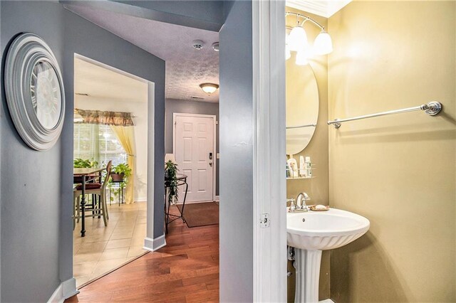 entryway with dark wood-type flooring and a textured ceiling