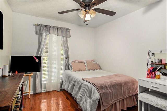 bedroom with dark hardwood / wood-style floors