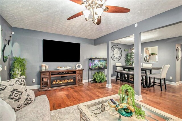 bedroom featuring a spacious closet, dark hardwood / wood-style floors, ceiling fan, and a closet