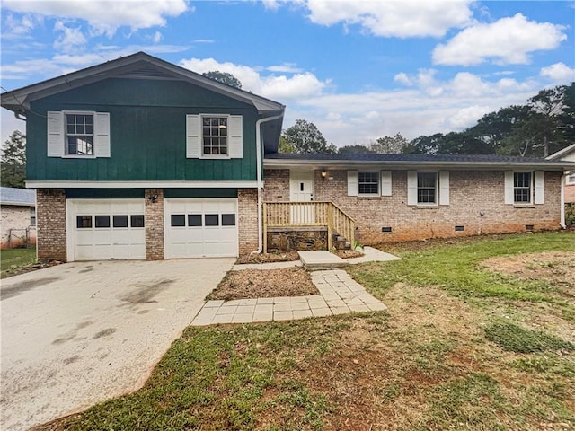 tri-level home featuring a front lawn and a garage