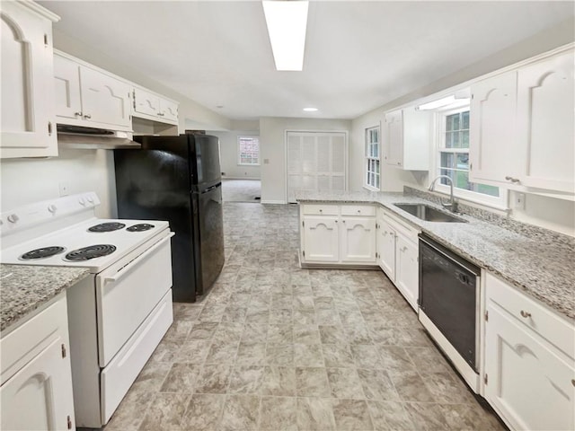 kitchen featuring light stone counters, white cabinets, sink, and black appliances