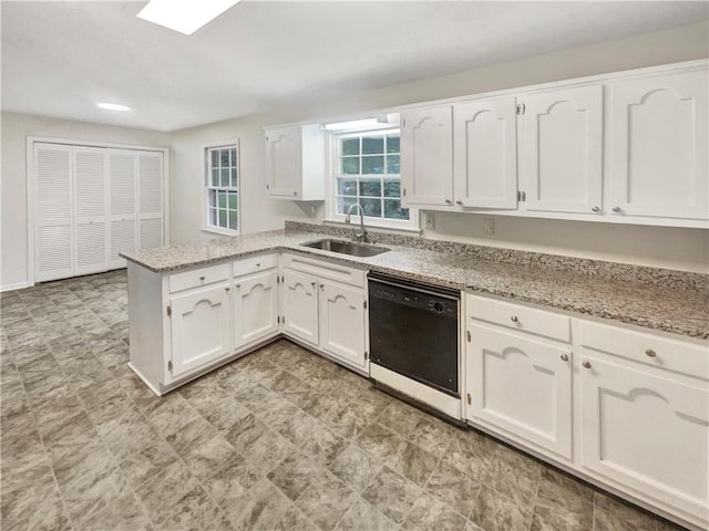 kitchen with black dishwasher, sink, kitchen peninsula, and white cabinetry